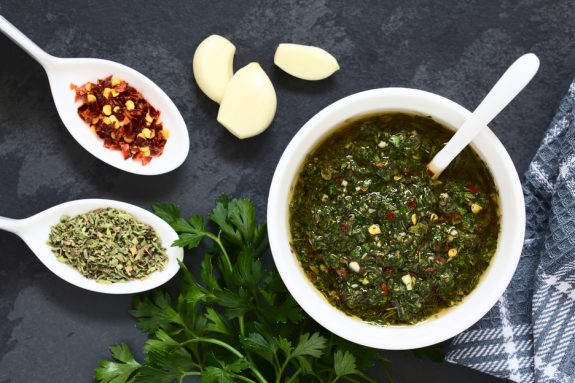 Aromatische Chimichurri mit frischer Petersilie, Knoblauch, Olivenöl, Paprikaflocken, Thymian, Oregano, Zwiebeln