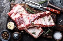 raw meat ribs on wooden cutting board
